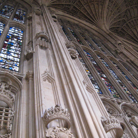 The inside of a big, ornate church with stained glass windows and very high ceilings.