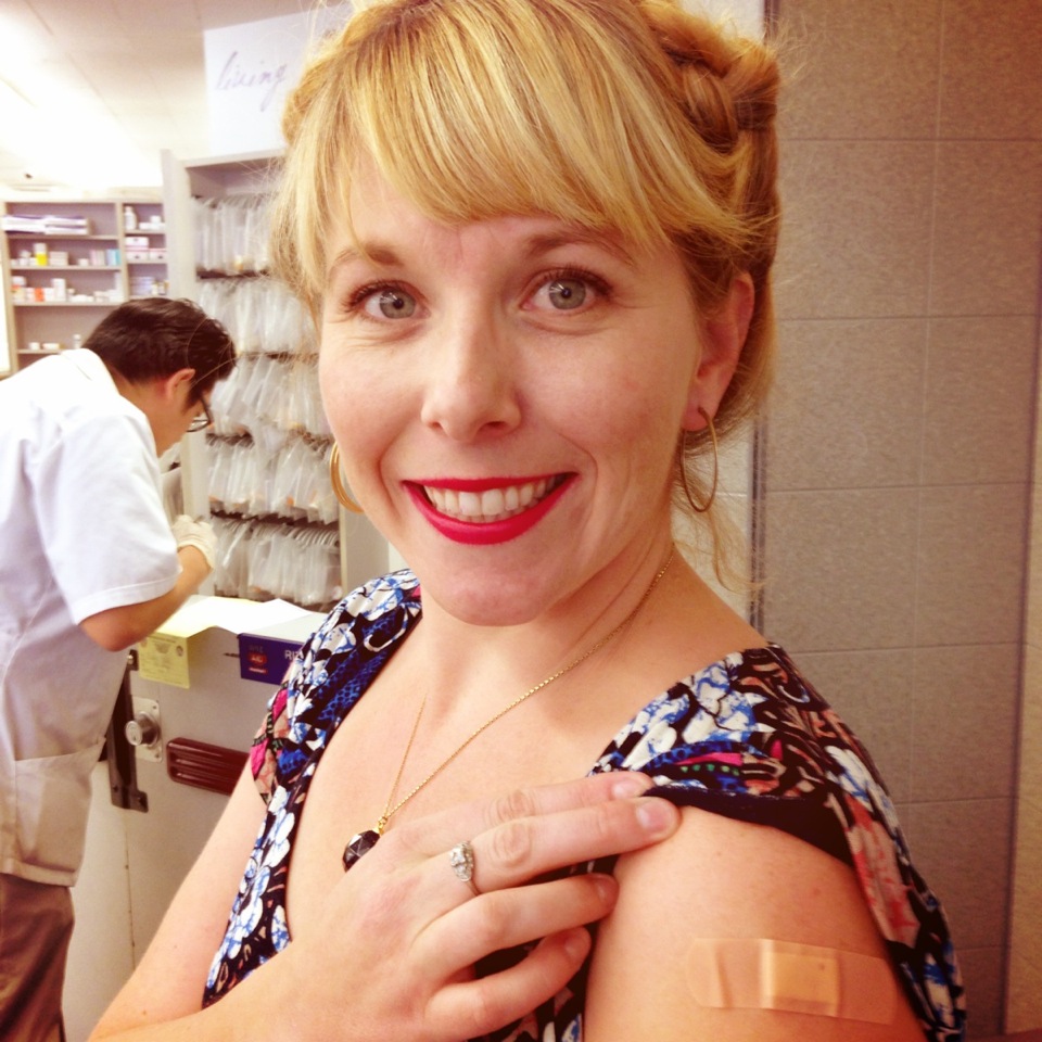 A woman shows off her vaccine bandage