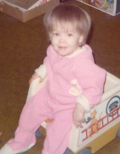 A little girl in fuzzy pink pajamas
