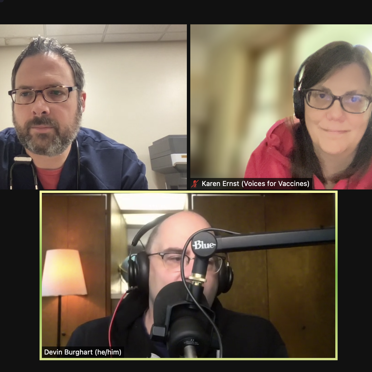 A Zoom screen with three people: a bearded, white doctor with glasses, and stunningly gorgeous white woman with brown hair and glasses, and a white man speaking into a large, radio-style microphone.