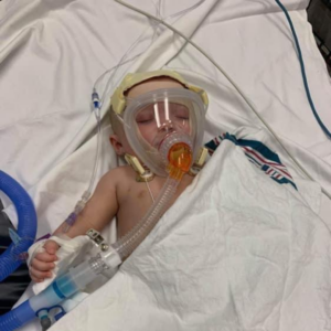 Roxanna's baby in the hospital with a breathing mask on because of RSV