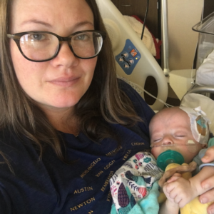 Lauren Throop holds her baby with breathing tubes because of RSV in the hospital