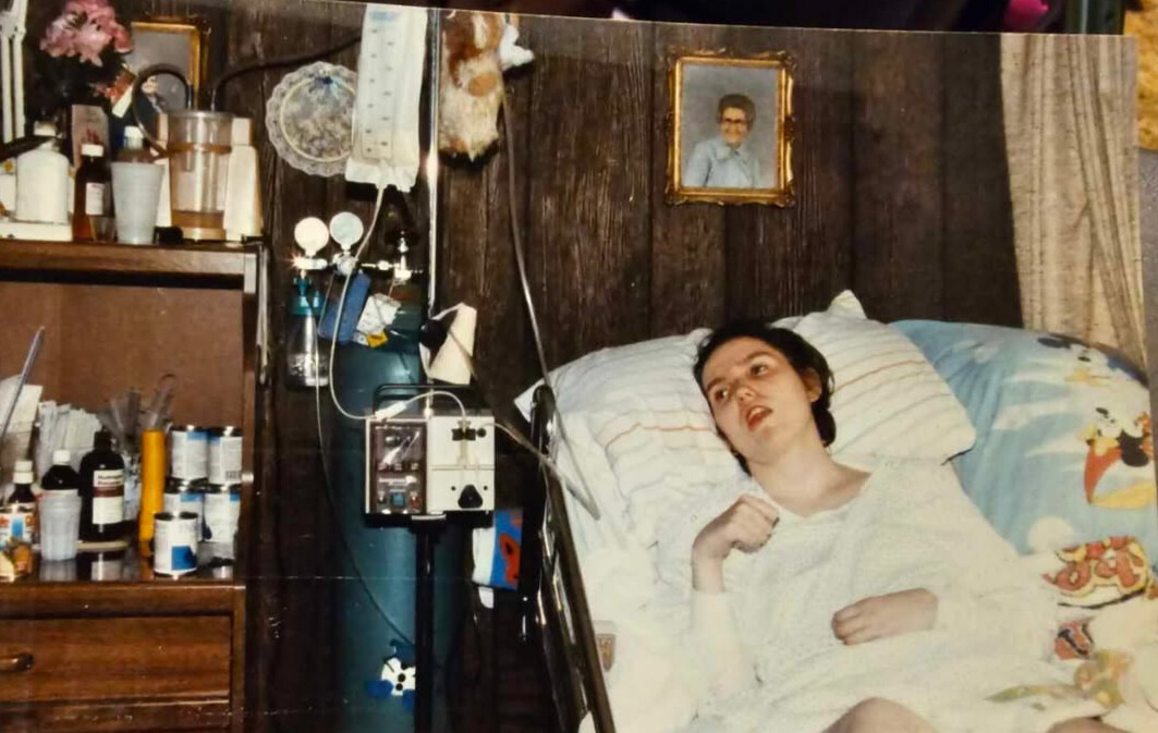 Dreama lies in her hospital bed, hooked up to an oxygen canister and an IV bag, zoning out.
