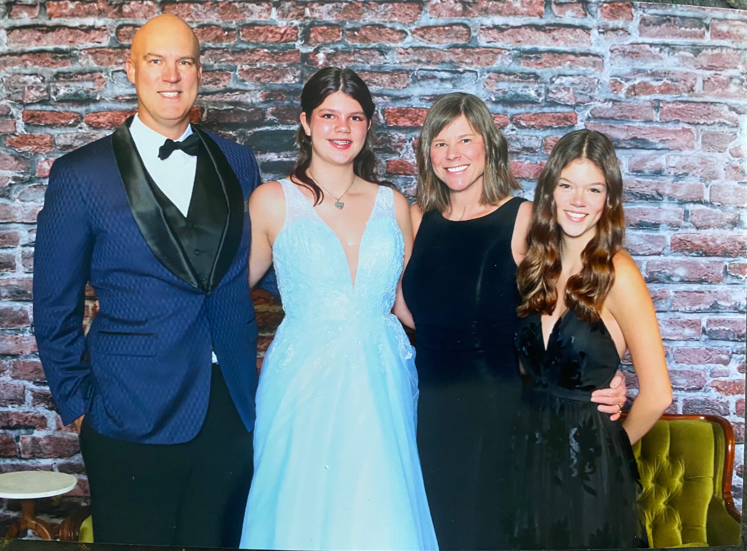 Sonia poses with her family. Everyone is dressed formally.